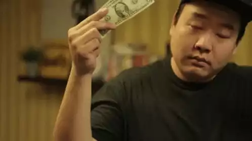Man Performs Dollar Bill Magic Trick
