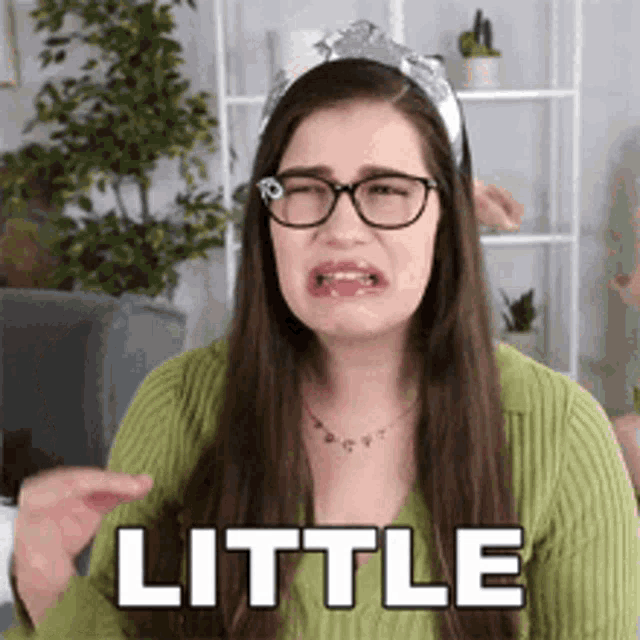 Woman Gestures 'Little' with Hand