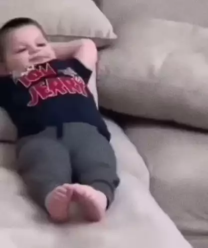 Cute Kid Chilling on Couch in Tom & Jerry Shirt
