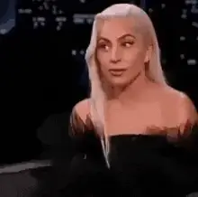 Lady Gaga Shrugs and Smiles