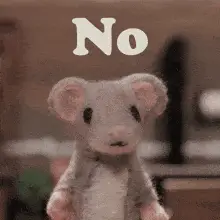 A stuffed toy mouse shaking its head: no