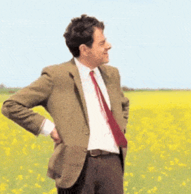 Mr. Bean Impatiently Checks Watch in Flower Field