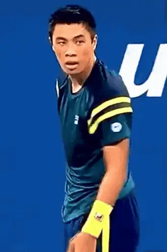 Brandon Nakashima Wipes Sweat During Tennis Match