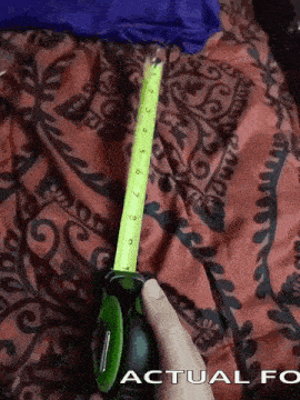 Hand Holding Retracting Tape Measure