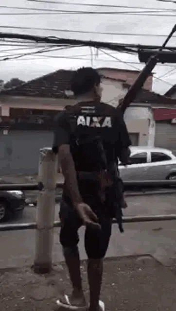 Armed Man Walking with Rifle