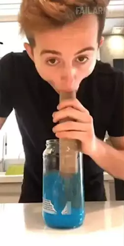 Man Attempts to Drink with Giant Straw