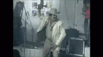 Beto Dancing Energetically in Cowboy Hat