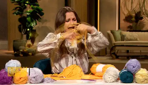 Woman Struggling with Knitting Yarn