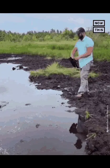 Man Jumps into Muddy Pit