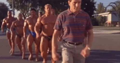 Hal from the sitcom Malcolm in the Middle walking around with body builders