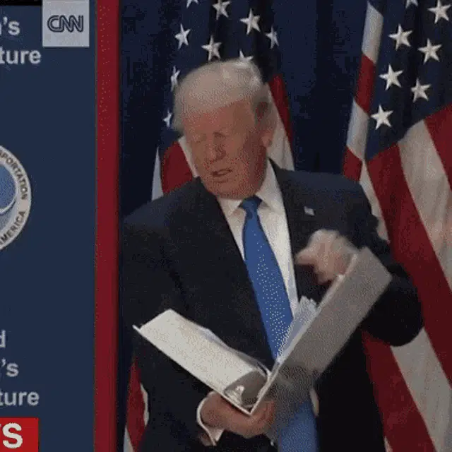 Donald Trump Flips Through Binder