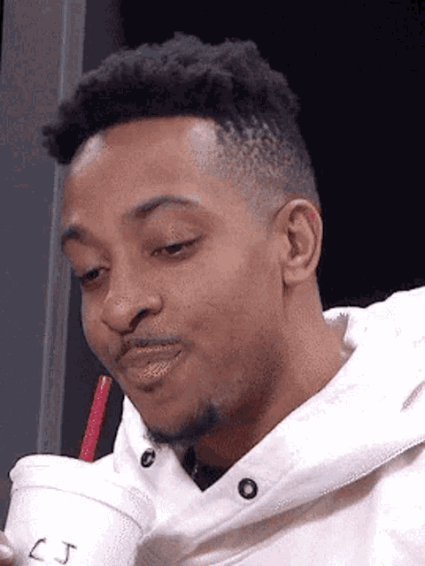 CJ McCollum Sips Drink with a Smile