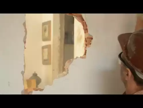 Man Breaking Through Wall
