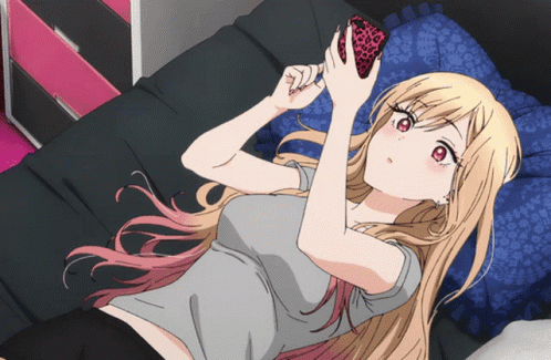 Marin Kitagawa from the anime 'My Dress-up Darling' using her smartphone