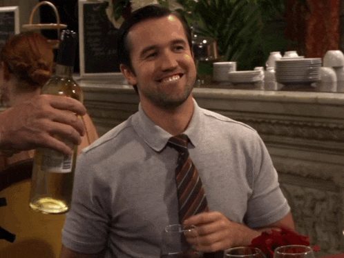 Mac (Rob McElhenney) with wine