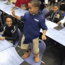 Excited Boy Dancing on Chair