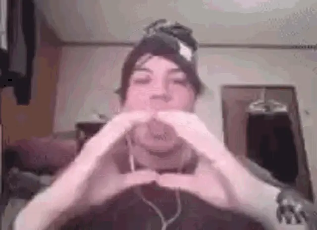 Man Making Heart Shape Gesture with Hands