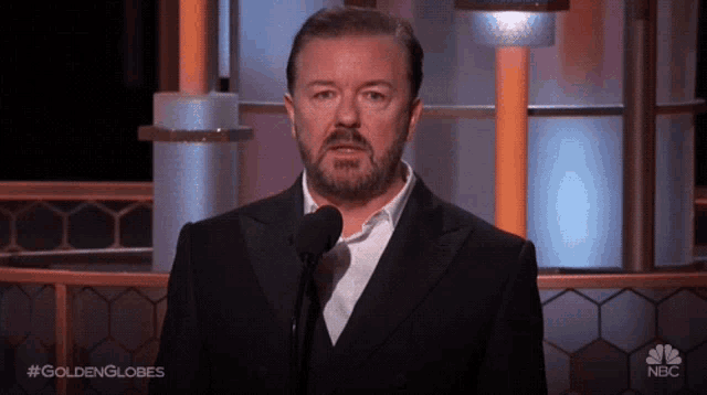 Ricky Gervais Checks Watch at Golden Globes
