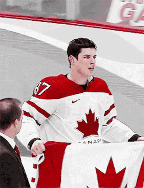 Sidney Crosby Holds Canadian Flag for Team Canada