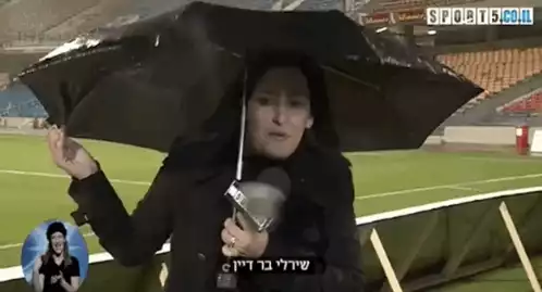 Shirley Bar Dayan Battles Wind with Umbrella
