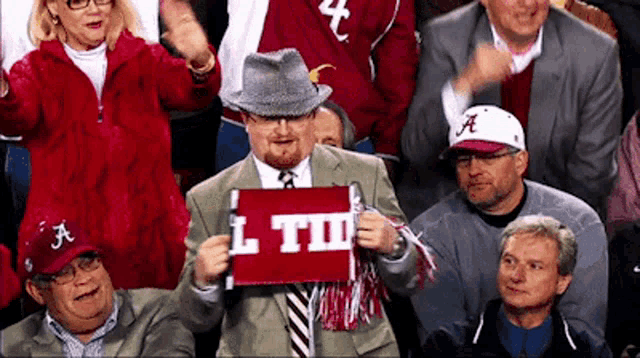 Alabama Crimson Tide Fans with 'Roll Tide' Banner