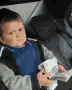Baby in car seat holding remote