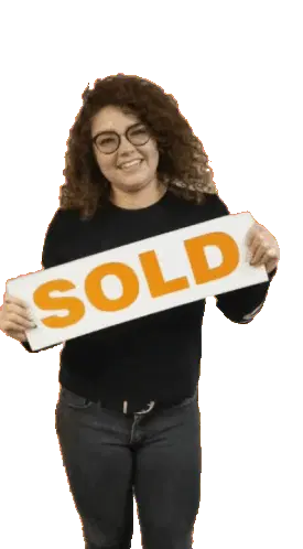 Mariana Lopez Holds 'Sold' Sign