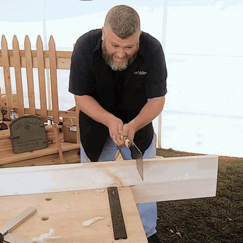 Woodworker Hand-Sawing Timber