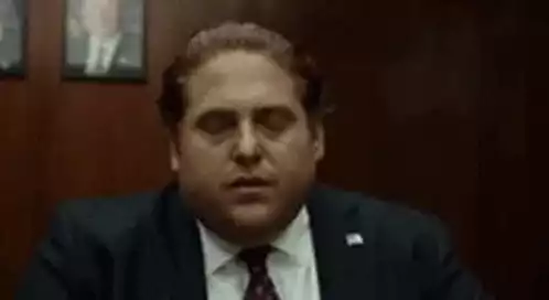 Man's Annoyed Reaction in Suit