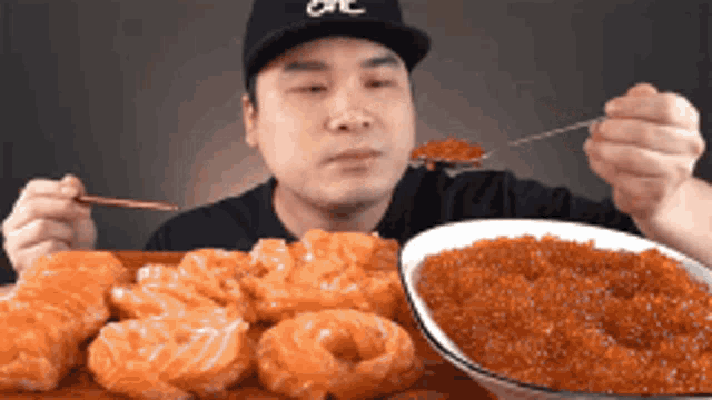 Man Eating Salmon Sashimi and Red Caviar