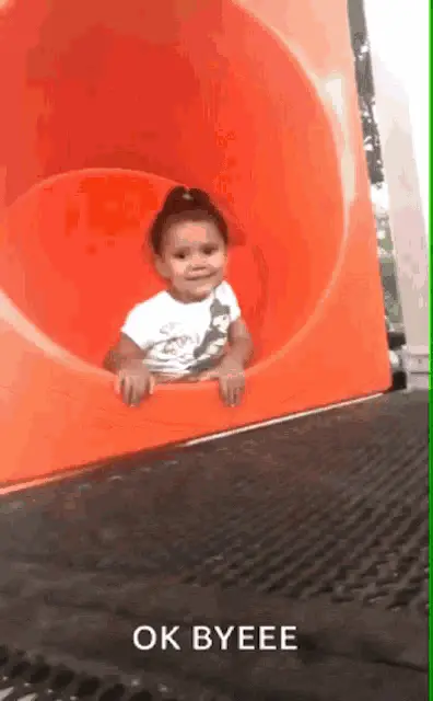Little Girl Waving Bye on a Slide