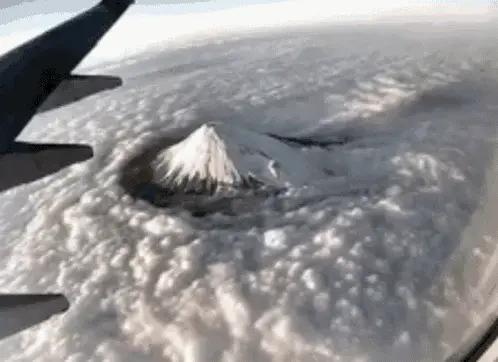 Aerial View of Mt Fuji Above Clouds from Plane