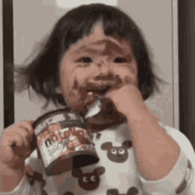Child Eating Nutella with Chocolate Face