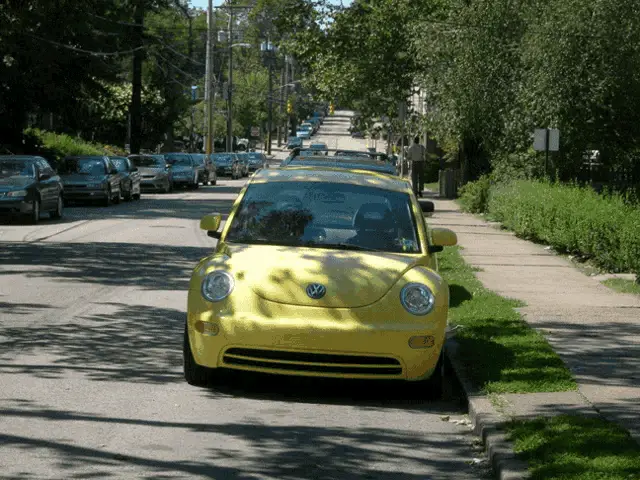 Bright Yellow Volkswagen Beetle Parked on Street