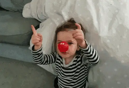 Little Girl with Red Nose Gives Thumbs Up