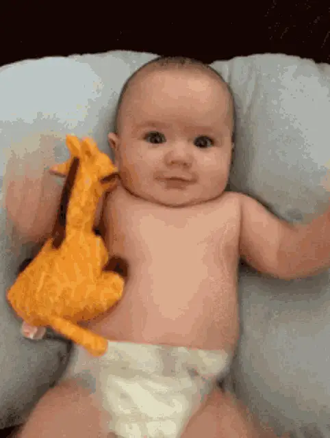 Smiling Baby with Giraffe Toy