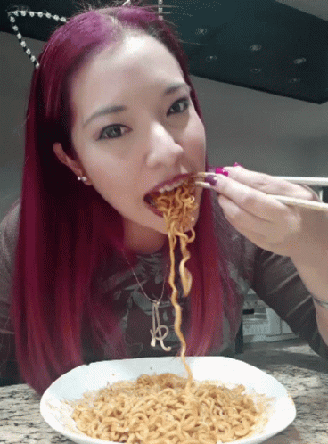 Woman Eating Noodles Ramen with Chopsticks