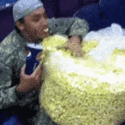 Man Devours Giant Popcorn Bag at Cinema
