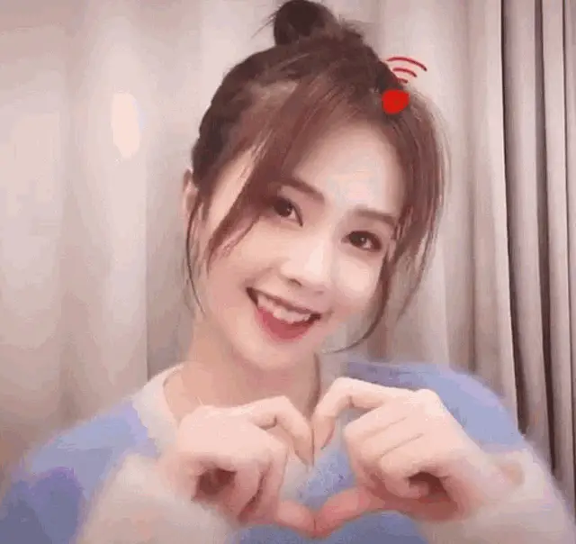 Bailu Bachloc Makes a Heart Gesture