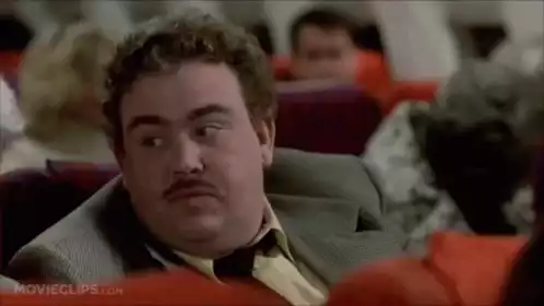 Man's Amused Reaction on an Airplane
