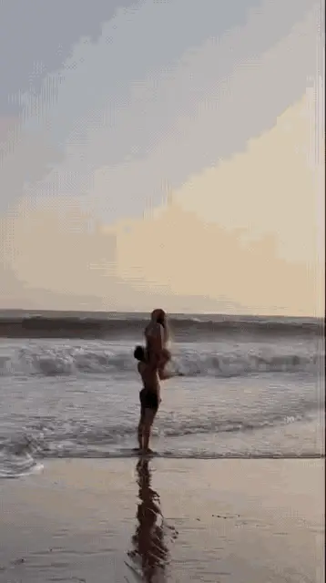 Flavia Laos Carried Playfully on the Beach